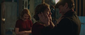 Movie still from “The Zookeeper's Wife” (2017), directed by Niki Caro – A woman is smiling while a man is touching her face; Medium shot, Over the shoulder angle
