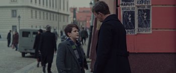 Movie still from “The Zookeeper's Wife” (2017), directed by Niki Caro – A man and a boy are talking on the sidewalk; Medium shot, Over the shoulder angle