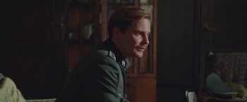 Movie still from “The Zookeeper's Wife” (2017), directed by Niki Caro – A person wearing a uniform; Close Up shot, Over the shoulder angle