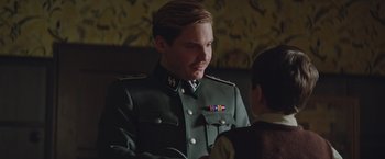 Movie still from “The Zookeeper's Wife” (2017), directed by Niki Caro – A man in a military uniform talking to another man; Close Up shot, Over the shoulder angle
