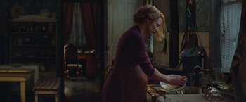 Movie still from “The Zookeeper's Wife” (2017), directed by Niki Caro – A woman standing in front of an open door; Medium shot, Over the shoulder angle