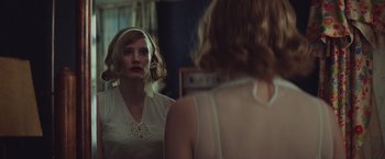 Movie still from “The Zookeeper's Wife” (2017), directed by Niki Caro – A woman looking in the mirror in front of a mirror; Close Up shot, Over the shoulder angle