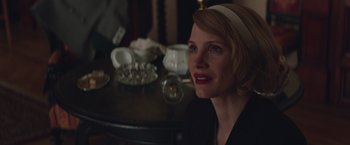 Movie still from “The Zookeeper's Wife” (2017), directed by Niki Caro – A woman sitting in front of a tea set on top of a table; Close Up shot, Over the shoulder angle