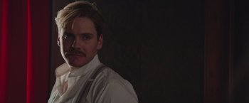 Movie still from “The Zookeeper's Wife” (2017), directed by Niki Caro – A man in a white shirt with a mustache and suspenders; Close Up shot, Low angle