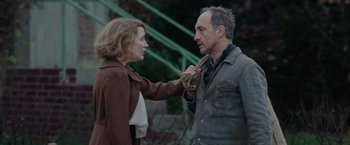 Movie still from “The Zookeeper's Wife” (2017), directed by Niki Caro – A man and a woman are holding hands; Medium shot, Low angle