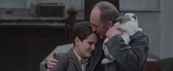 Movie still from “The Zookeeper's Wife” (2017), directed by Niki Caro – An older man and a young boy hugging each other; Close Up shot, Over the shoulder angle