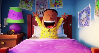 Movie still from “Captain Underpants: The First Epic Movie” (2017), directed by David Soren – A cartoon of a person in a bed with a smile on his face; Medium shot, Low angle