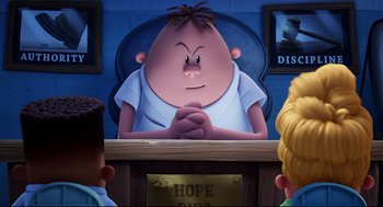 Movie still from “Captain Underpants: The First Epic Movie” (2017), directed by David Soren – A cartoon of a man sitting in front of two other people; Medium shot, Low angle