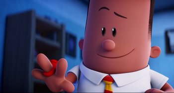 Movie still from “Captain Underpants: The First Epic Movie” (2017), directed by David Soren – A cartoon character holding a button; Close Up shot, Over the shoulder angle