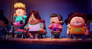 Movie still from “Captain Underpants: The First Epic Movie” (2017), directed by David Soren – A group of cartoon characters sitting on top of a stage; Wide shot, Low angle