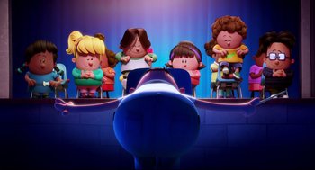 Movie still from “Captain Underpants: The First Epic Movie” (2017), directed by David Soren – A group of children sitting in front of an airplane; Wide shot, Low angle
