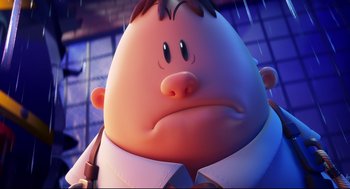 Movie still from “Captain Underpants: The First Epic Movie” (2017), directed by David Soren – An animated picture of a man with a frowning face; Close Up shot, Low angle
