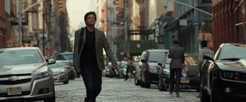 Movie still from “This Is Where I Leave You” (2014), directed by Shawn Levy – A man walking down a street holding a cell phone; Medium shot, Over the shoulder angle