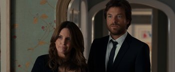 Movie still from “This Is Where I Leave You” (2014), directed by Shawn Levy – A man and a woman standing next to each other holding a baby; Close Up shot, Over the shoulder angle