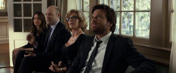 Movie still from “This Is Where I Leave You” (2014), directed by Shawn Levy – A man and a woman sitting next to each other in front of another man; Medium shot, Over the shoulder angle
