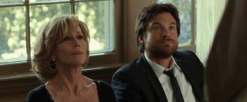 Movie still from “This Is Where I Leave You” (2014), directed by Shawn Levy – A man and a woman sitting next to each other in front of a window; Close Up shot, Over the shoulder angle