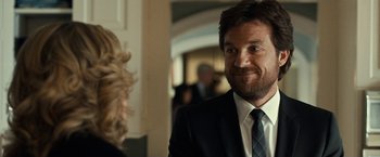 Movie still from “This Is Where I Leave You” (2014), directed by Shawn Levy – A man wearing a suit and tie smiling at the camera; Close Up shot, Over the shoulder angle