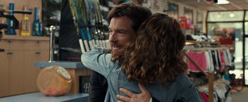 Movie still from “This Is Where I Leave You” (2014), directed by Shawn Levy – A man and a woman hugging each other in a store; Close Up shot, Over the shoulder angle
