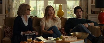 Movie still from “This Is Where I Leave You” (2014), directed by Shawn Levy – A woman sitting on top of a couch in a living room; Medium shot, Over the shoulder angle