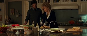 Movie still from “This Is Where I Leave You” (2014), directed by Shawn Levy – A woman and a man in a kitchen preparing a meal; Medium shot, Over the shoulder angle