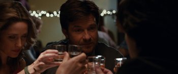 Movie still from “This Is Where I Leave You” (2014), directed by Shawn Levy – A group of people holding glasses of water and drinking; Close Up shot, Over the shoulder angle