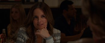Movie still from “This Is Where I Leave You” (2014), directed by Shawn Levy – A woman sitting in front of a man in front of a table; Close Up shot, Over the shoulder angle