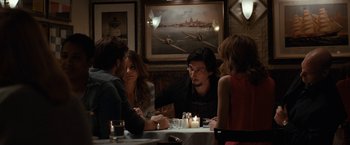 Movie still from “This Is Where I Leave You” (2014), directed by Shawn Levy – A group of people sitting at a table with candles; Medium shot, Over the shoulder angle