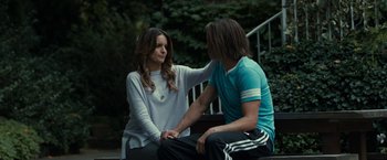 Movie still from “This Is Where I Leave You” (2014), directed by Shawn Levy – A man and a woman sitting next to each other on a bench; Medium shot, Over the shoulder angle