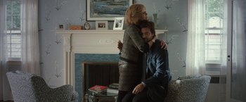 Movie still from “This Is Where I Leave You” (2014), directed by Shawn Levy – A man and a woman sitting in a living room next to a fire place; Medium shot, Over the shoulder angle