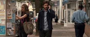 Movie still from “This Is Where I Leave You” (2014), directed by Shawn Levy – A man talking on a cell phone while walking down the street; Medium shot, Over the shoulder angle