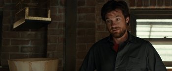 Movie still from “This Is Where I Leave You” (2014), directed by Shawn Levy – A man standing in a room next to a brick wall; Close Up shot, Over the shoulder angle