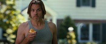 Movie still from “This Is Where I Leave You” (2014), directed by Shawn Levy – A person holding a piece of food; Close Up shot, Over the shoulder angle