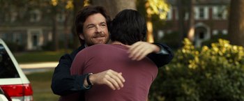Movie still from “This Is Where I Leave You” (2014), directed by Shawn Levy – A man hugging another man in a park; Medium shot, Over the shoulder angle