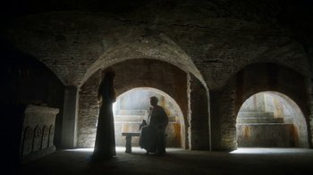 Movie still from “Game of Thrones” (2011), created by D.B. Weiss – A man and a woman are standing in a room; Wide shot, Low angle