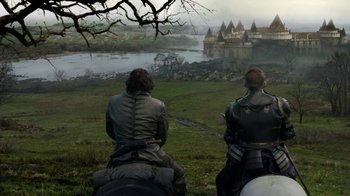 Movie still from “Game of Thrones” (2011), created by D.B. Weiss – Two men on horseback looking out at a castle on a hill; Wide shot, High angle