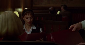 Movie still from “Carol” (2015), directed by Todd Haynes – A woman sitting at a table in front of a book; Close Up shot, Over the shoulder angle