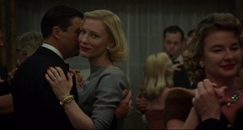Movie still from “Carol” (2015), directed by Todd Haynes – A man and a woman dancing in front of other people; Close Up shot, Low angle