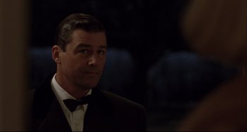 Movie still from “Carol” (2015), directed by Todd Haynes – A man in a suit and bow tie looking to his left; Close Up shot, Over the shoulder angle