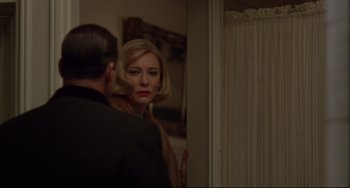 Movie still from “Carol” (2015), directed by Todd Haynes – A man and a woman looking in the same mirror; Close Up shot, Over the shoulder angle