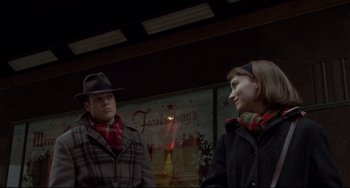 Movie still from “Carol” (2015), directed by Todd Haynes – A man and a woman standing next to each other; Medium shot, Over the shoulder angle