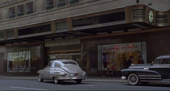 Movie still from “Carol” (2015), directed by Todd Haynes – An old car parked on the side of the street; Extreme Wide shot, High angle