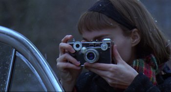 Movie still from “Carol” (2015), directed by Todd Haynes – A woman taking a picture with a camera; Extreme Close Up shot, Over the shoulder angle