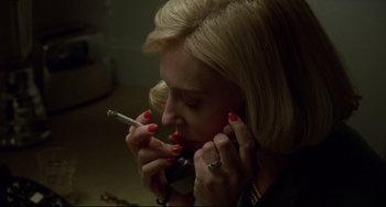 Movie still from “Carol” (2015), directed by Todd Haynes – A woman is smoking a cigarette while talking on the phone; Close Up shot, High angle