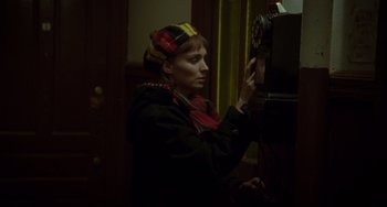 Movie still from “Carol” (2015), directed by Todd Haynes – A woman is looking at a clock on the wall; Close Up shot, High angle
