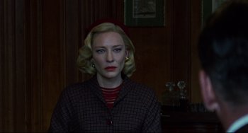Movie still from “Carol” (2015), directed by Todd Haynes – A woman with a red hat and a plaid jacket; Close Up shot, Low angle