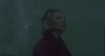 Movie still from “Carol” (2015), directed by Todd Haynes – A woman in a red jacket is looking to the side; Close Up shot, Low angle