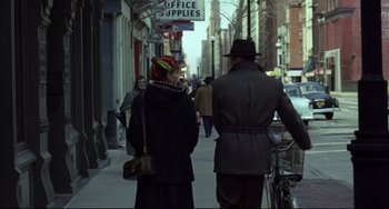 Movie still from “Carol” (2015), directed by Todd Haynes – A man and a woman walking down a street; Wide shot, Over the shoulder angle
