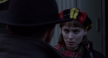 Movie still from “Carol” (2015), directed by Todd Haynes – A woman wearing a hat looking into a mirror; Close Up shot, Over the shoulder angle