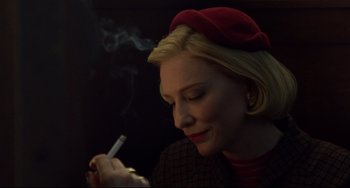 Movie still from “Carol” (2015), directed by Todd Haynes – A woman in a red hat is smoking a cigarette; Close Up shot, Over the shoulder angle