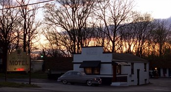 Movie still from “Carol” (2015), directed by Todd Haynes – An old car parked in front of a building; Extreme Wide shot, Low angle